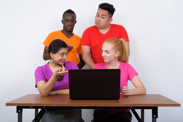 Studio shot of diverse group of multi ethnic friends talking whi