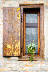 Fototapeta na wymiar Old wooden window and decorative flowers