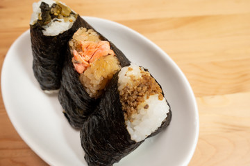 Various types of traditional Japanese rice balls, called Onigiri, wrapped with seaweed.	