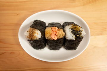 Various types of traditional Japanese rice balls, called Onigiri, wrapped with seaweed.	