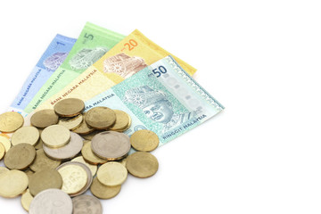 Malaysia Ringgit notes and coins on a white background.