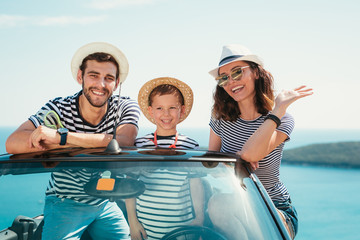 Happy family travel by car to the sea. People having fun in cabriolet. Summer vacation concept