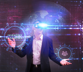 Business, Technology, Internet and network concept. Young businessman working in virtual reality glasses sees the inscription: Inventory management