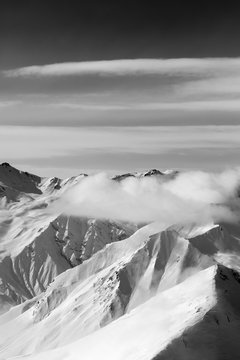 Fototapeta Black and white snow mountains in clouds