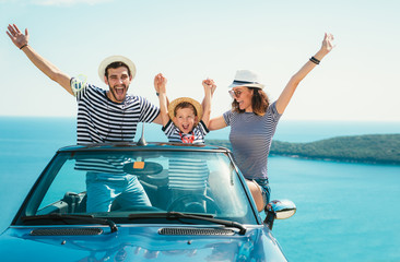 Happy family travel by car to the sea. People having fun in cabriolet. Summer vacation concept