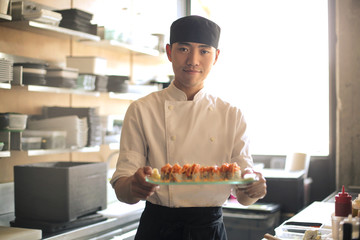 Chef serving sushi in a restaurant