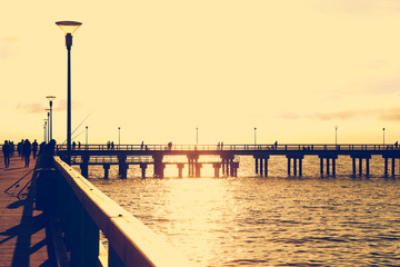 Wooden sea bridge at sunset. Pedestrian bridge at the Baltic sea  in Palanga. Toned.