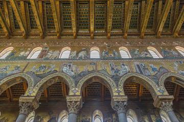 Fototapeta na wymiar Interior of norman cathedral Santa Maria Nuova in Monreale near Palermo in Sicily is famous for its Byzantine mosaics. Walls are decorated with mosaics depicting scenes from old and new testaments 