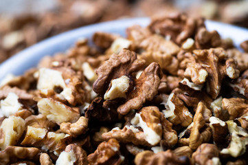 Walnuts kernels with color background, Whole walnut in a metal plate. Walnuts. Walnuts an market. Background of walnuts. Healthy.