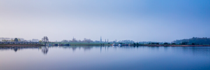 Obraz premium Dutch river landscape during blue hour. View from the Island of Maurik in Gelderland, Netehralds