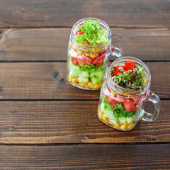Glass jars with vegetable salad. Top view. Healthy food, Diet, D