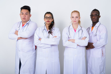 Studio shot of diverse group of multi ethnic doctors standing wi