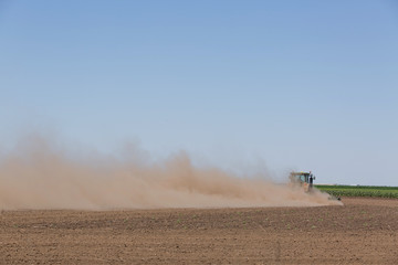 Fototapeta premium 20.06.2018 Ukraine, the Kherson region. The tractor plows the earth, on a hot summer day