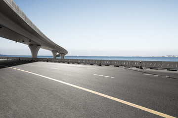 asphalt road with city skyline