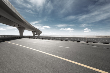 asphalt road with city skyline