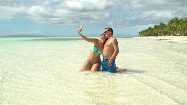A man with a woman makes selfi at sea