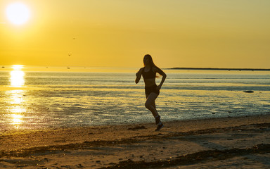 girl running by the sea on the beach