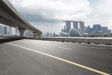 asphalt road with city skyline