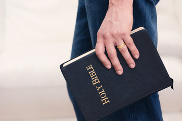Man Holding Bible to His Side