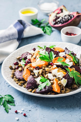 Healthy vegetarian salad, roasted root vegetables, lentils and feta cheese. Selective focus, space...
