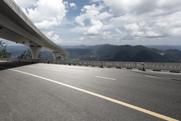 asphalt road with city skyline