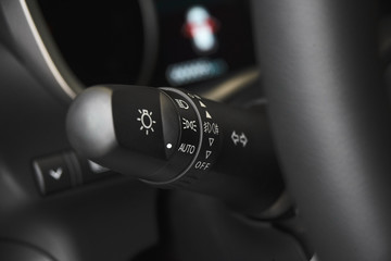 Changing headlight stick of modern car close-up. Car light control system