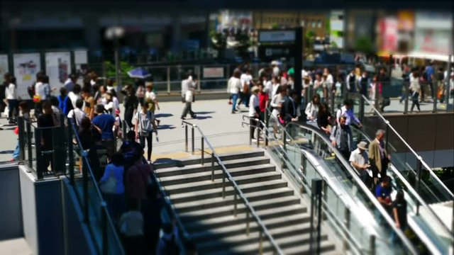 Time lapse of anonymous crowd of people walking on escalator in rush hour.
