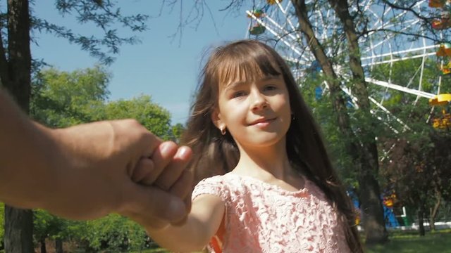 Kidnapping. Stealing a child. A little girl is holding a man's hand.