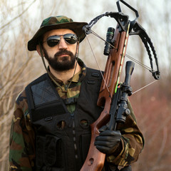military man with crossbow