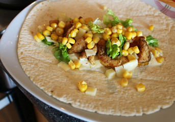 Healthy tortilla with meat, salad, cheese and corn