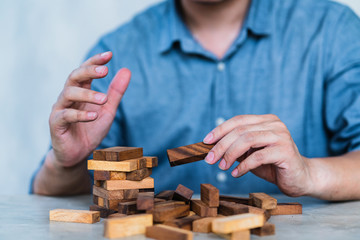 hand pull important color block from balance wooden stack business strategy and risk management control concept