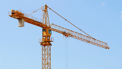 Construction crane against blue sky.