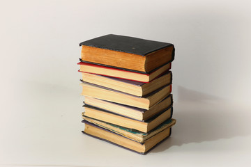 a stack of old books on a white background