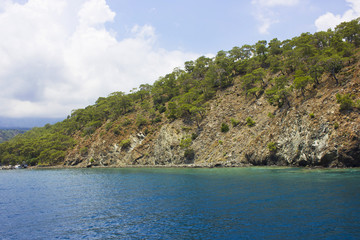 Naklejka premium Calm Mediterranean Sea and mountains with green trees in Antalya