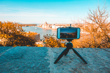 smartphone on tripod is filming the danube river at budapest