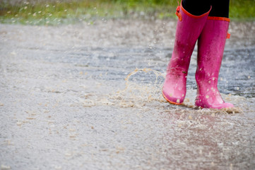 Pink wellies in the rain at a festival