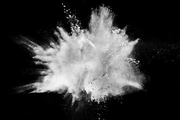 Launched white powder splash on black background.Stopping the movement of white powder on dark...