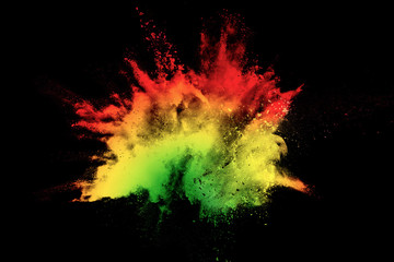 Abstract multicolored powder splatter on black background,Freeze motion of color powder splash....