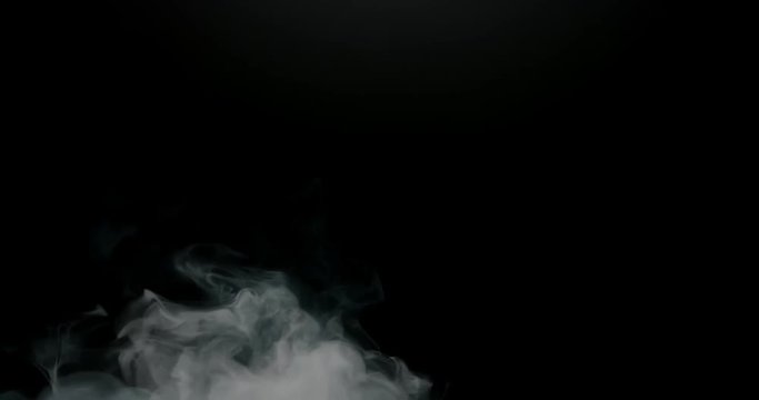 Thick smoke slowly filling frame studio shot against black background