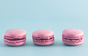 Pink French Macarons on a Blue Background