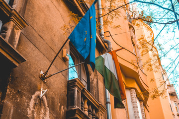 hungary and europe flag on an ancient orange building