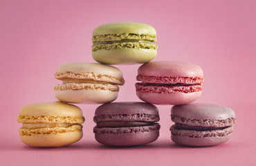 A Variety of French Macarons Flavors  on a Pink Background
