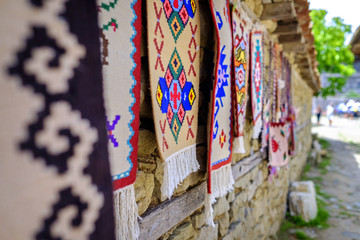 Colorful carpets on the wall in village street