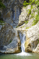 Fototapeta na wymiar Landscape of mountain waterfall in sunny weather 4