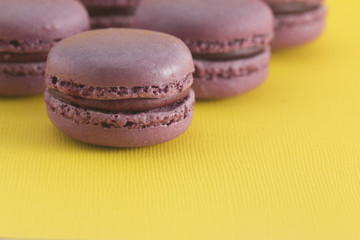 Purple French Macarons on a Yellow Background