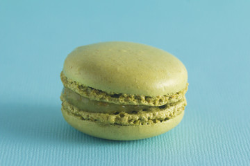 Green French Macarons on a Blue Background