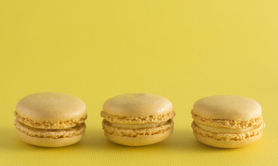 Yellow French Macarons on a Yellow Background