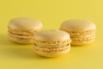 Yellow French Macarons on a Yellow Background