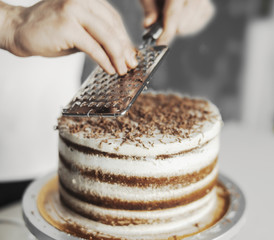 Young attractive man decorating cake