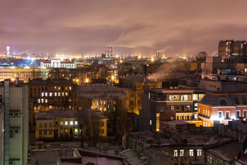 A view of the rooftops in the night from a height